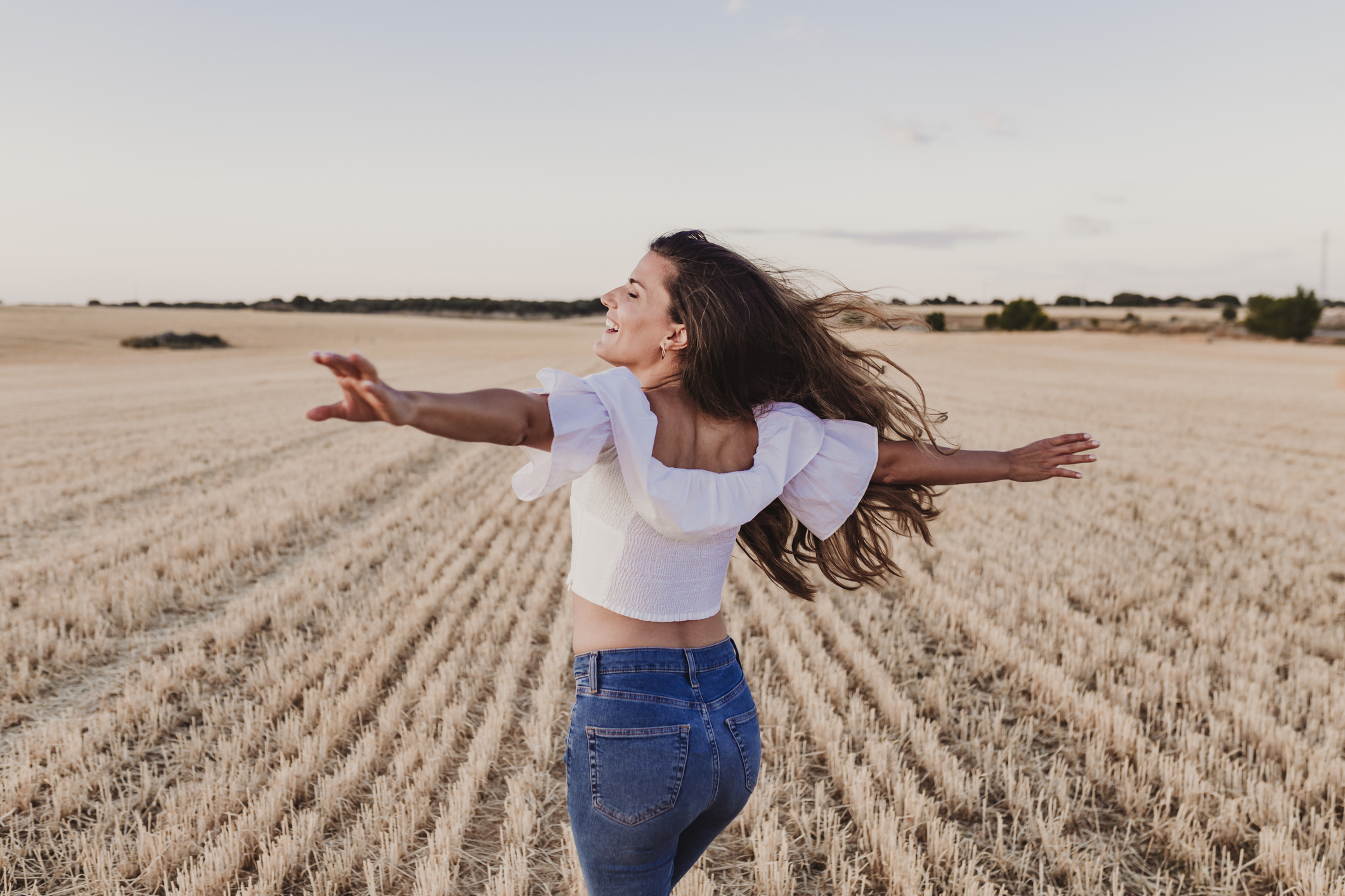 summer-girl-enjoying-nature-on-yellow-field-beautiful-young-woman-dancing-outdoors-long-hair-in-the-wind-happiness-and-960254350625 Woman in nature looking free and happy. Reconnection comes before reinvention.