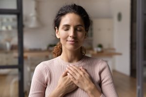 Reconnection comes before reinvention. A woman in a coaching space, reconnecting within. Listening to her inner voice.